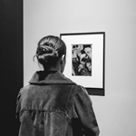 Woman looking at a Diane Arbus photo